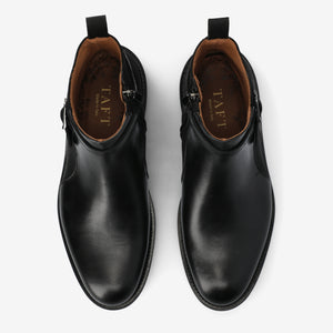 Pair of black leather boots with 'TAFT' branding on a white background