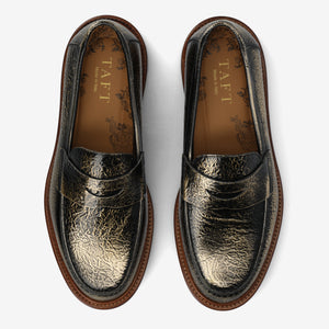 Pair of black leather loafers with gold embossed design with the label 'TAFT' on a white background
