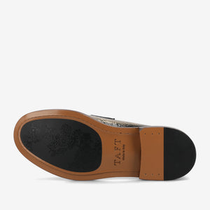 Men's dress shoe sole with 'Taft' branding and black floral print on a white background