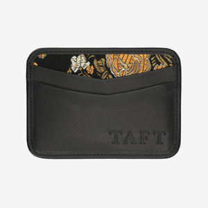 Black wallet with floral patterned flap and 'TAFT' branding on a white background